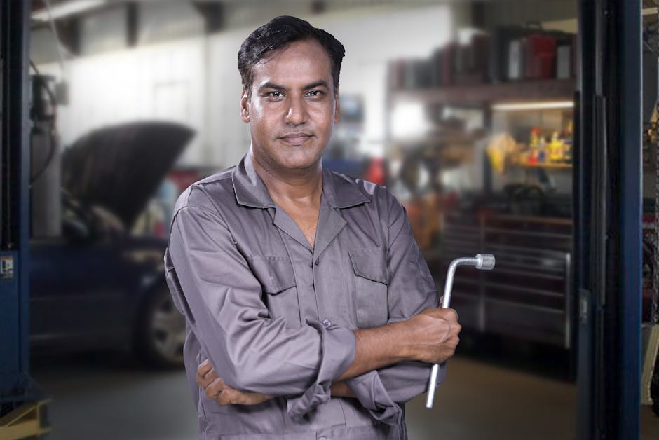 Smiling auto glass mechanic ready for service