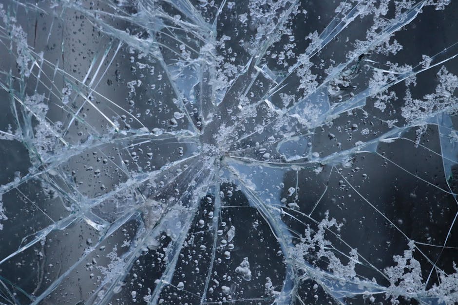 Close up of a cracked car windshield requiring replacement